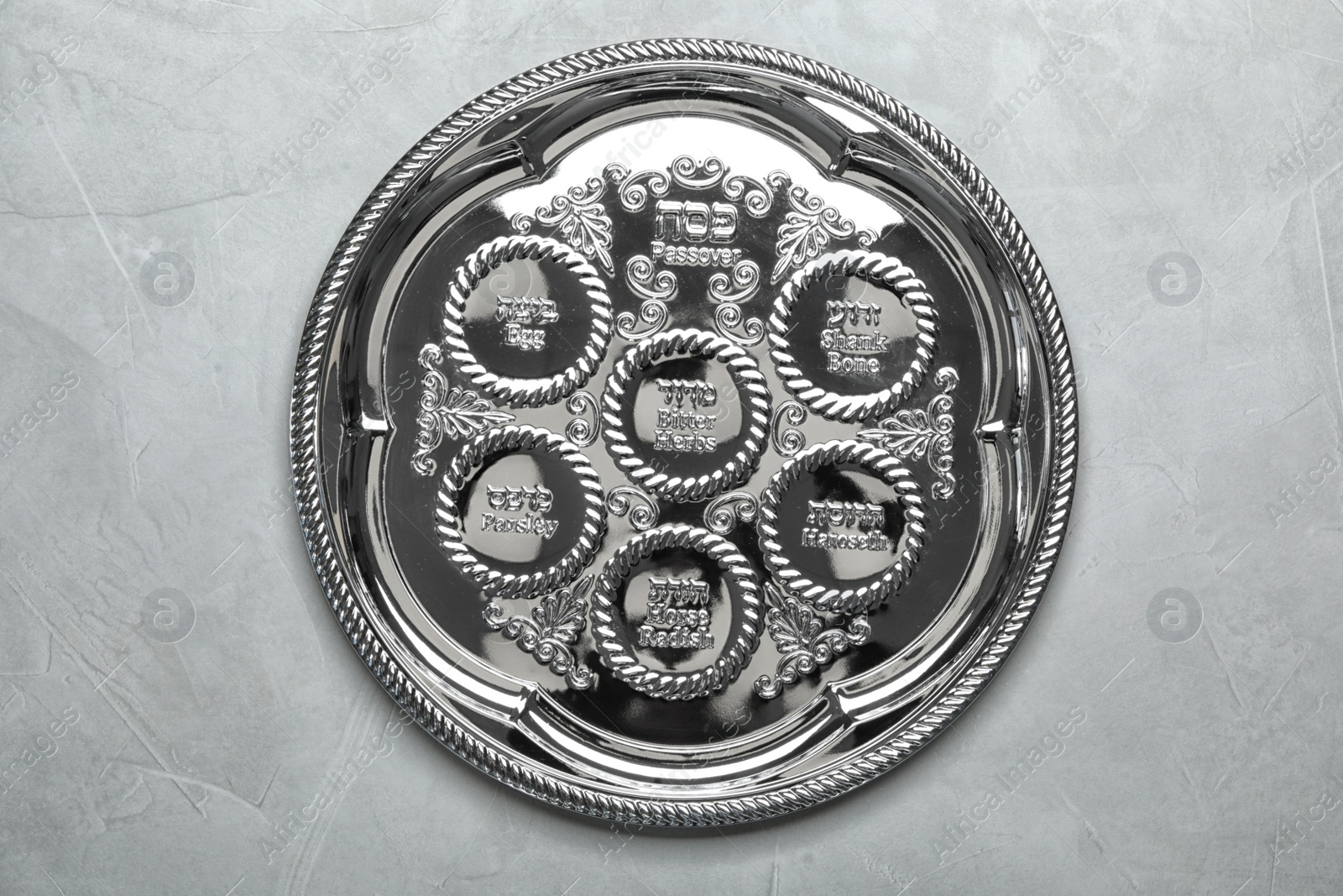 Photo of Empty traditional Passover (Pesach) Seder plate on color background, top view