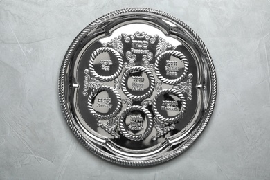 Photo of Empty traditional Passover (Pesach) Seder plate on color background, top view