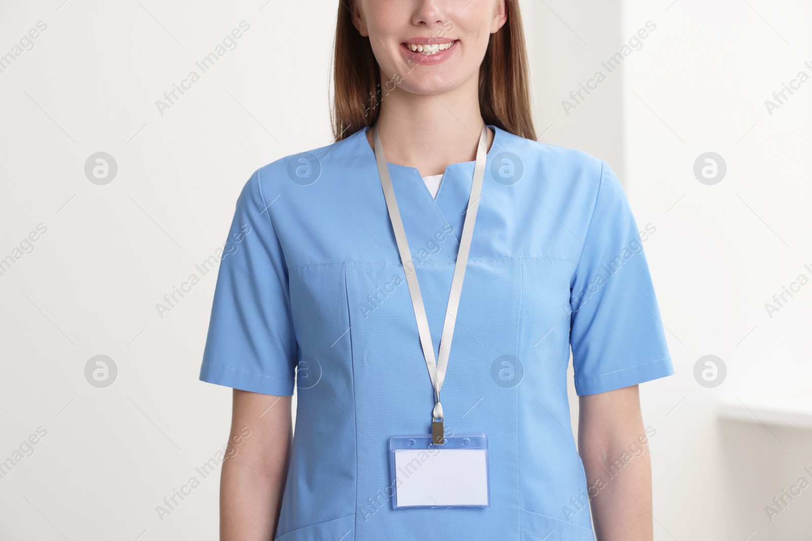 Photo of Doctor with blank badge in hospital, closeup