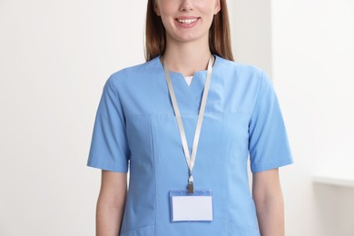 Photo of Doctor with blank badge in hospital, closeup