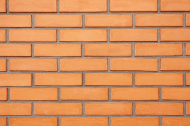 Photo of Texture of orange brick wall as background, closeup view