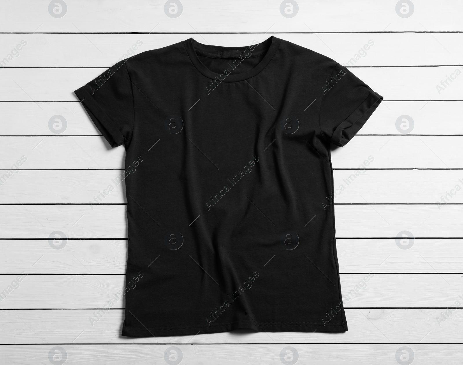 Photo of Stylish black t-shirt on white wooden background, top view