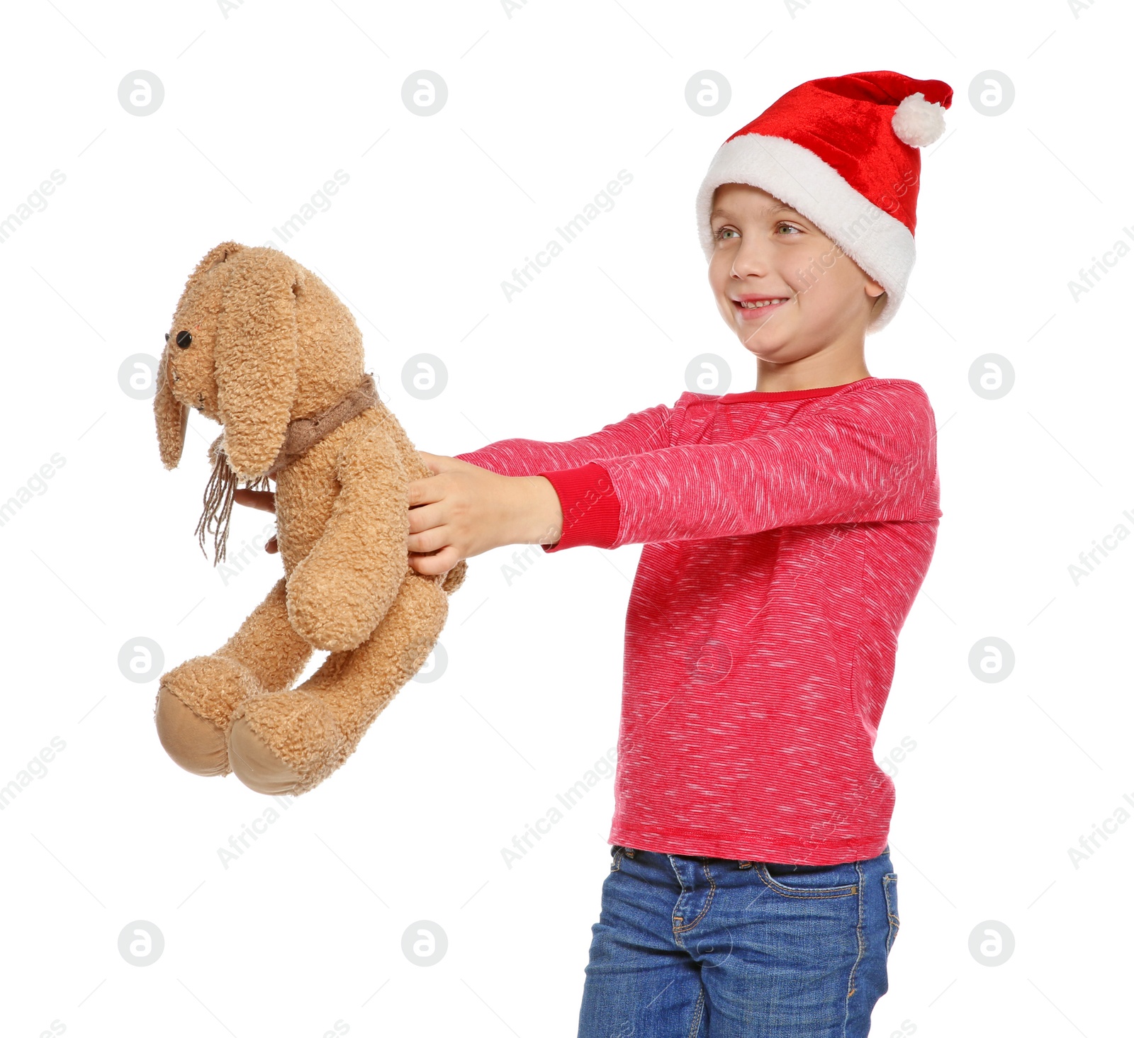 Photo of Cute little child in Santa hat with toy rabbit on white background. Christmas celebration