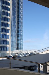 Photo of Open car parking with ramp near skyscraper on sunny day