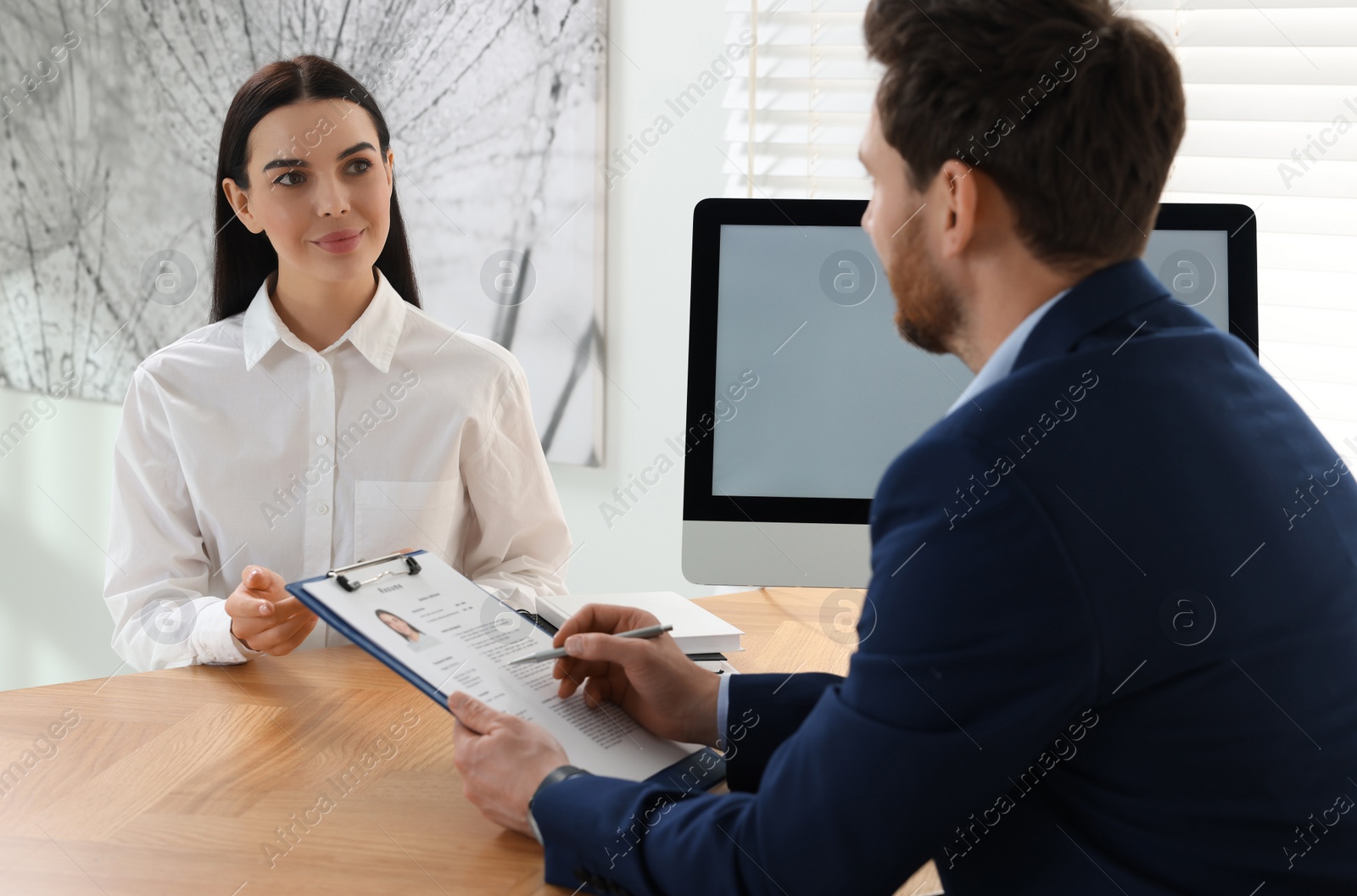 Photo of Human resources manager conducting job interview with applicant in office