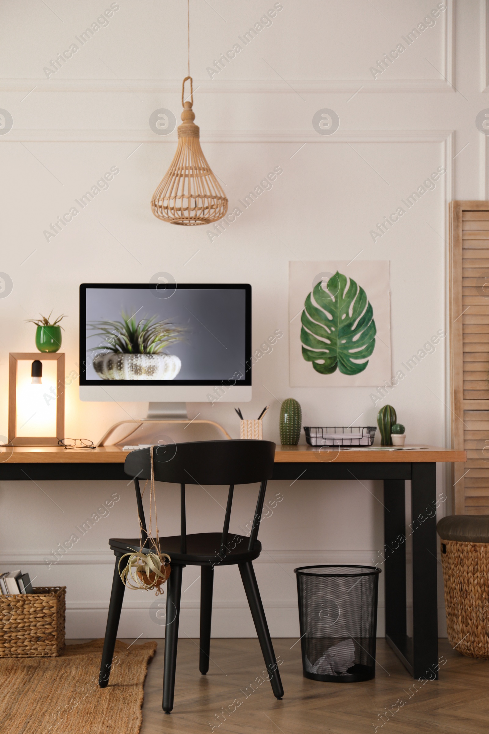 Photo of Modern workplace with computer in room. Interior design