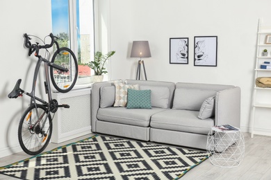 Photo of Modern living room interior with bicycle near wall