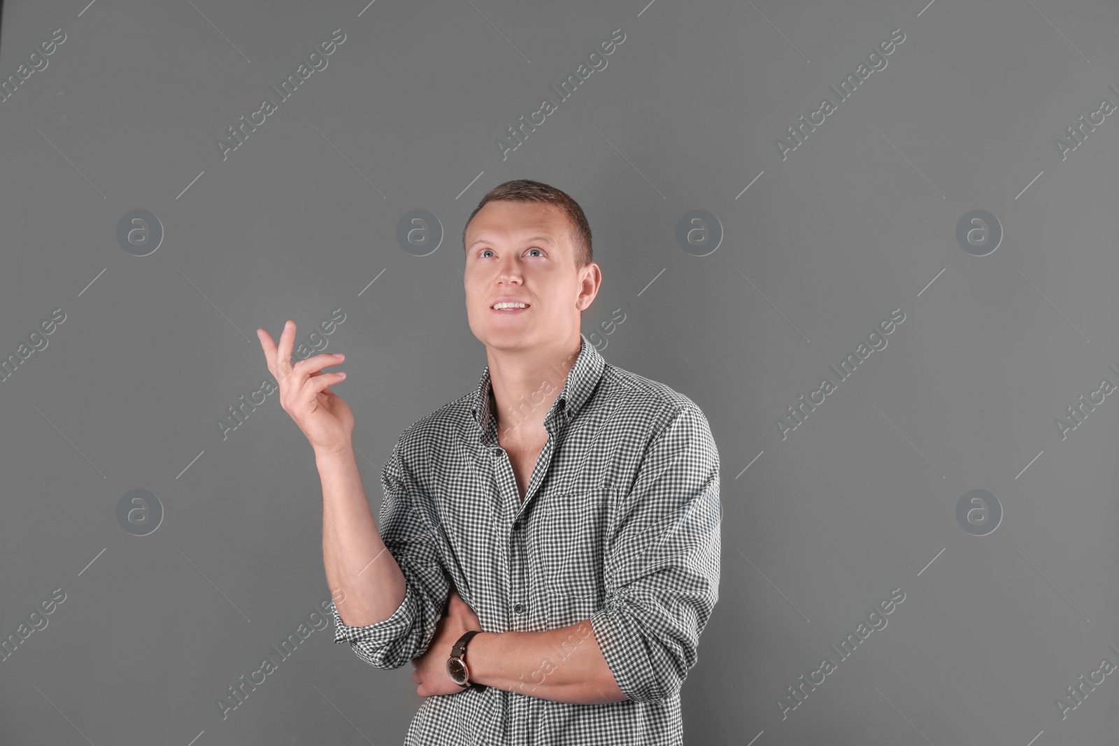 Photo of Handsome young man on color background