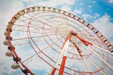 Photo of Beautiful large Ferris wheel outdoors, low angle view