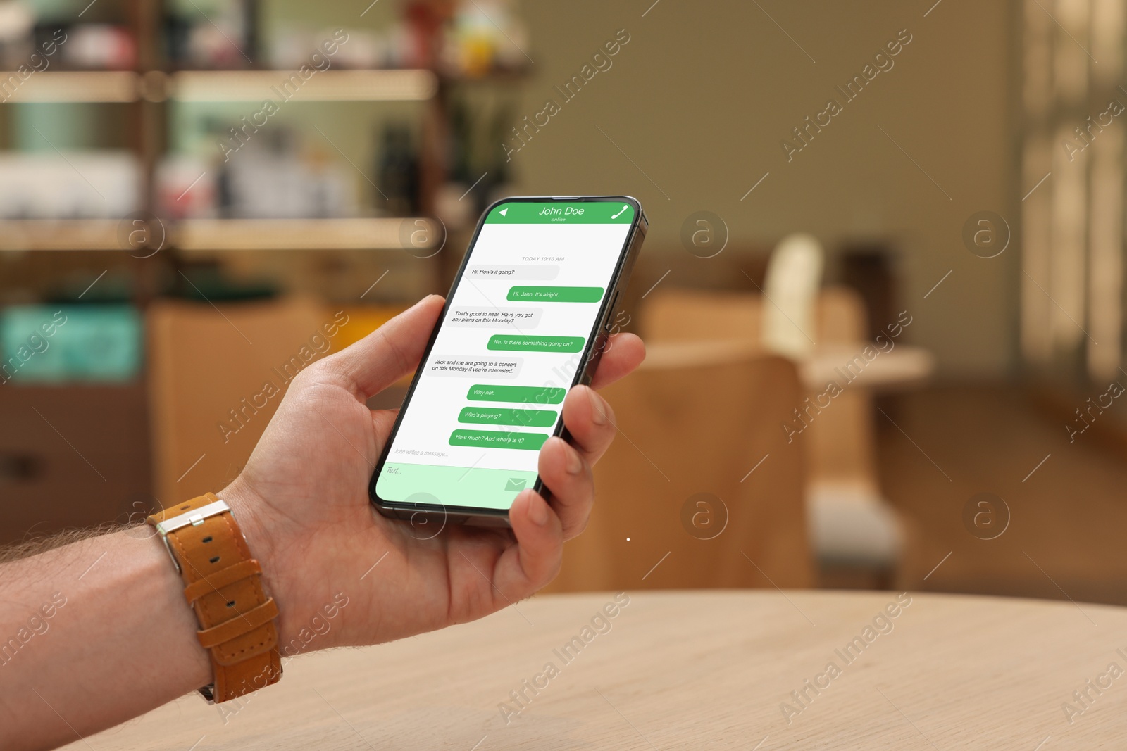 Image of Man texting via mobile phone indoors, closeup. Device screen with messages