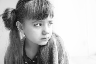 Photo of Portrait of sad little girl, black and white effect