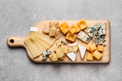 Cheese plate on grey table, top view