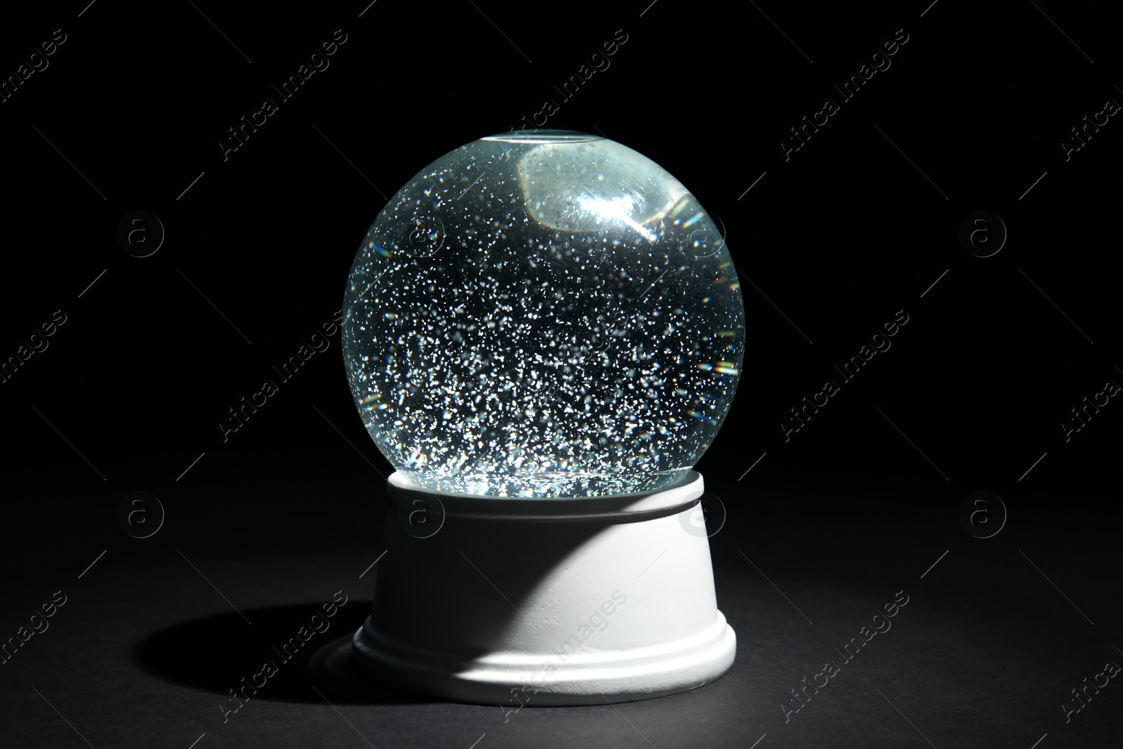 Photo of Magical empty snow globe on dark background