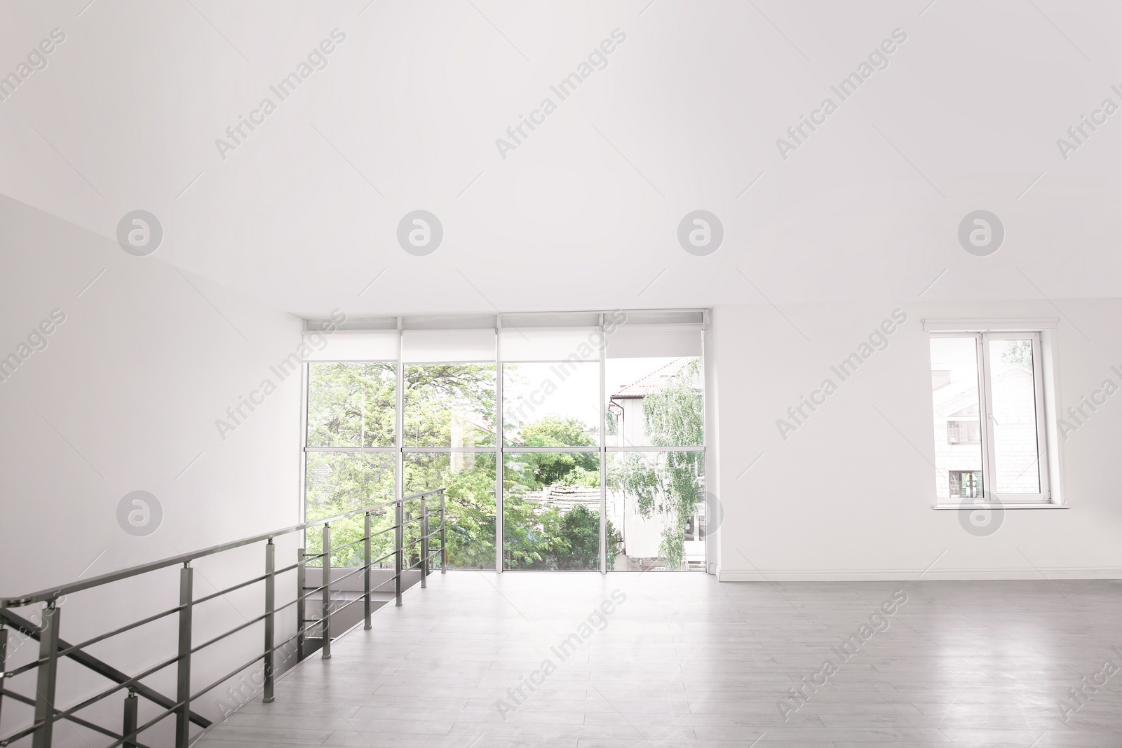 Photo of Empty room with windows and laminated floor