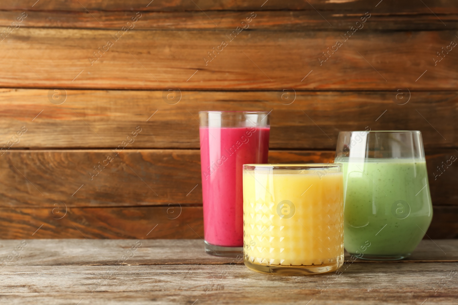 Photo of Glasses with delicious detox smoothies on table