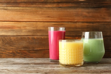 Photo of Glasses with delicious detox smoothies on table