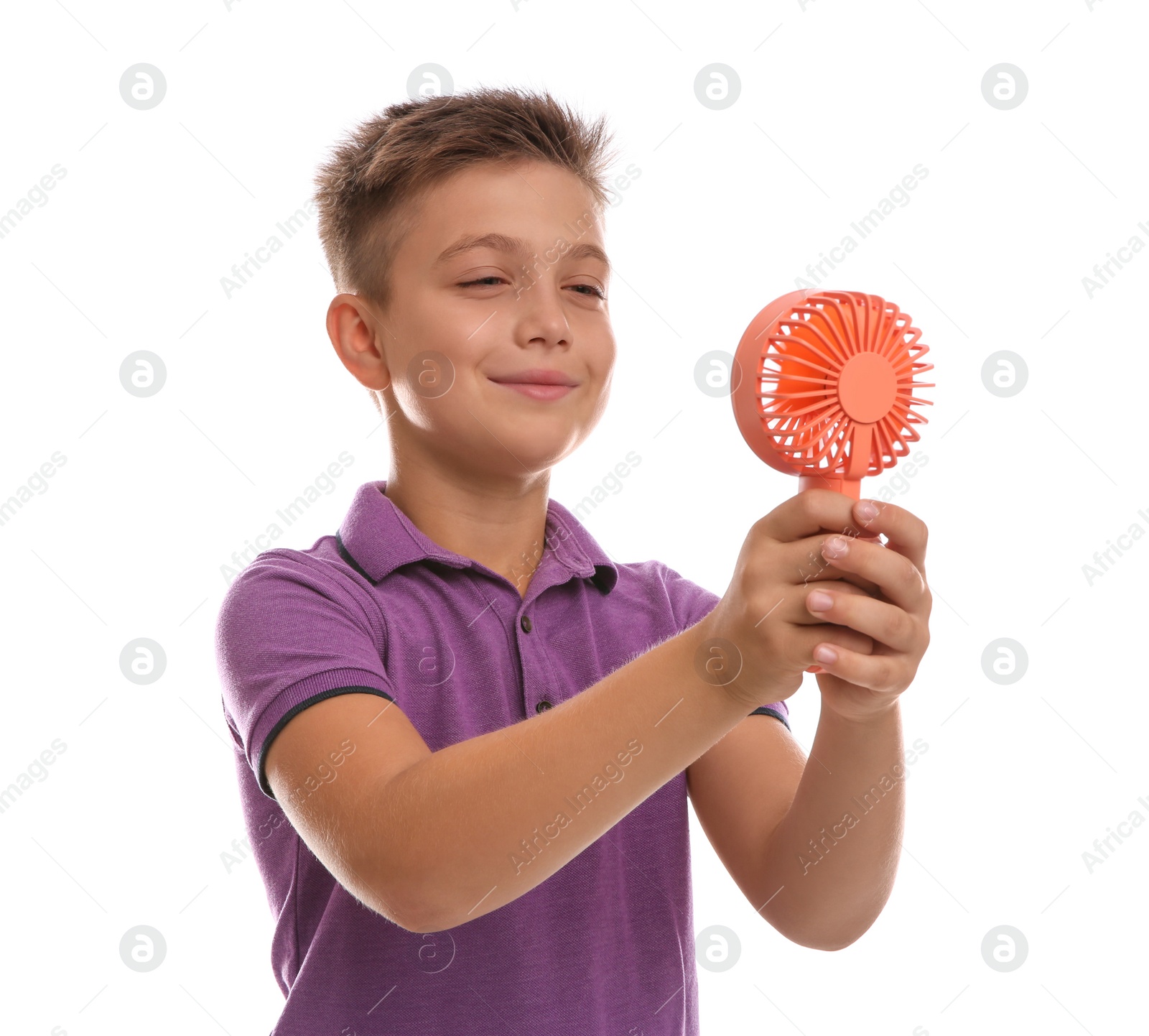 Photo of Little boy enjoying air flow from portable fan on white background. Summer heat