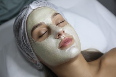 Photo of Beautiful woman with mask on her face in spa salon