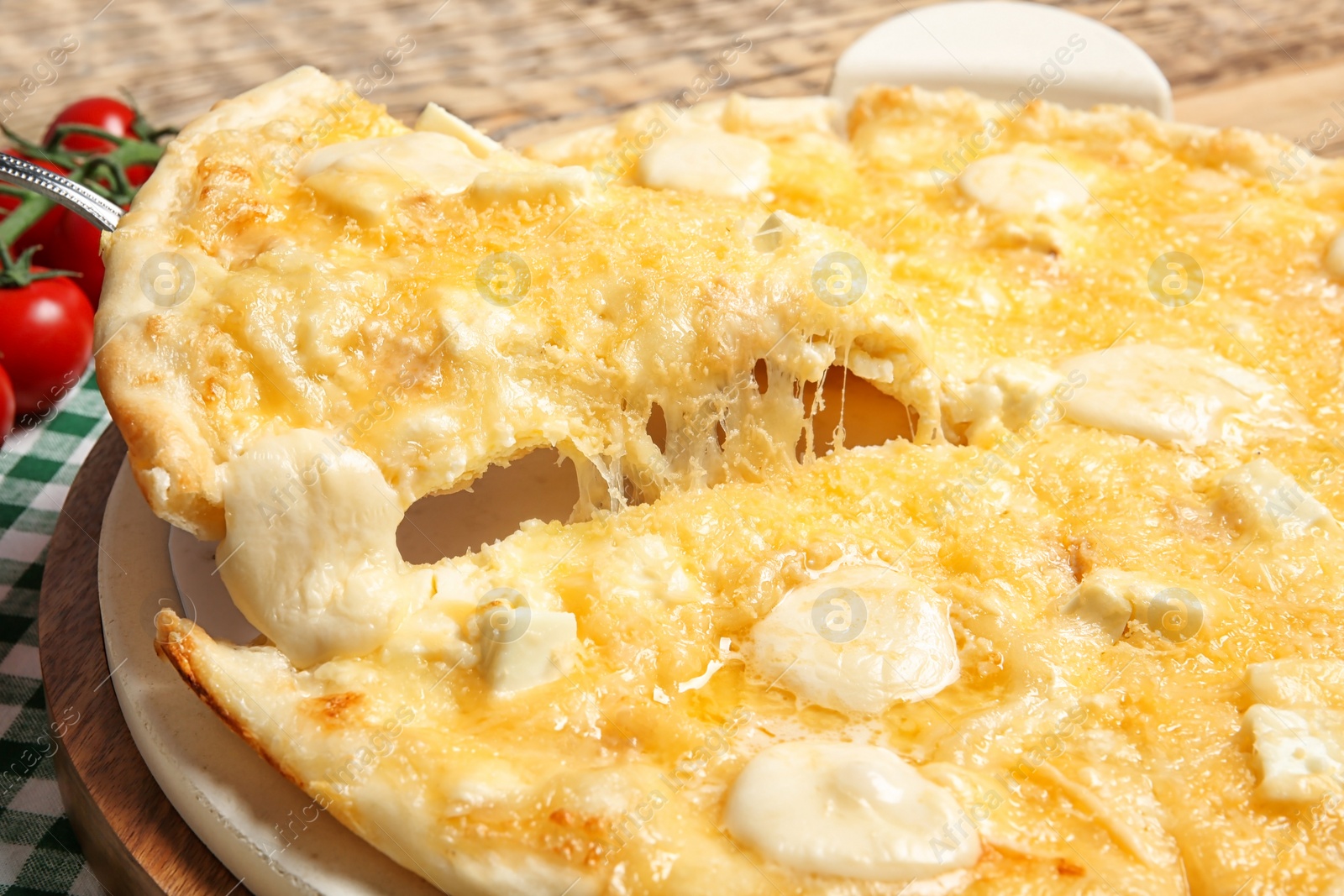 Photo of Taking tasty homemade pizza slice with melted cheese, closeup