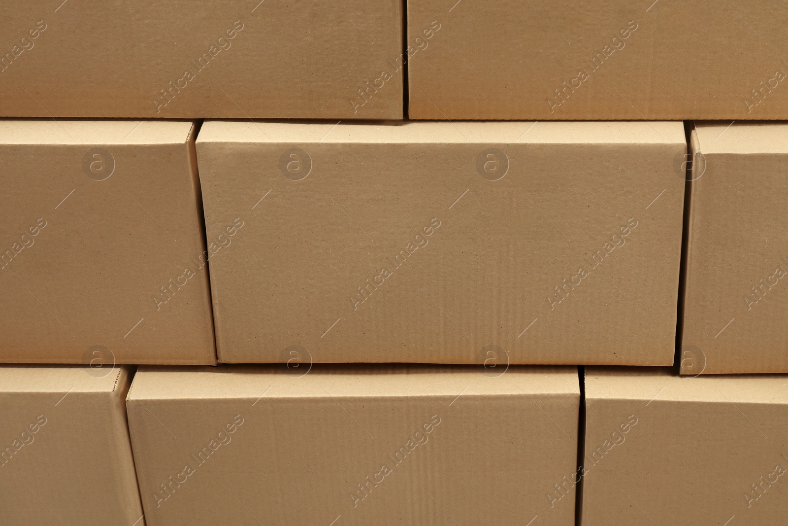 Photo of Stack of many closed cardboard boxes as background