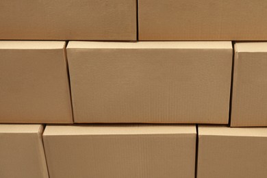 Photo of Stack of many closed cardboard boxes as background
