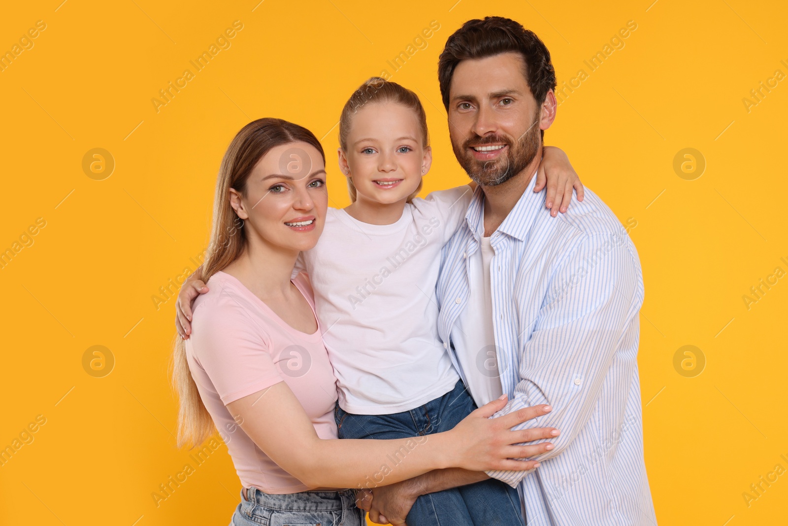 Photo of Portrait of happy family on orange background