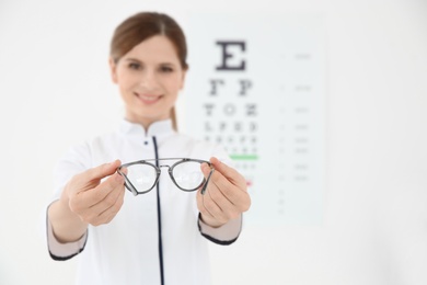 Photo of Female ophthalmologist with eyeglasses in clinic