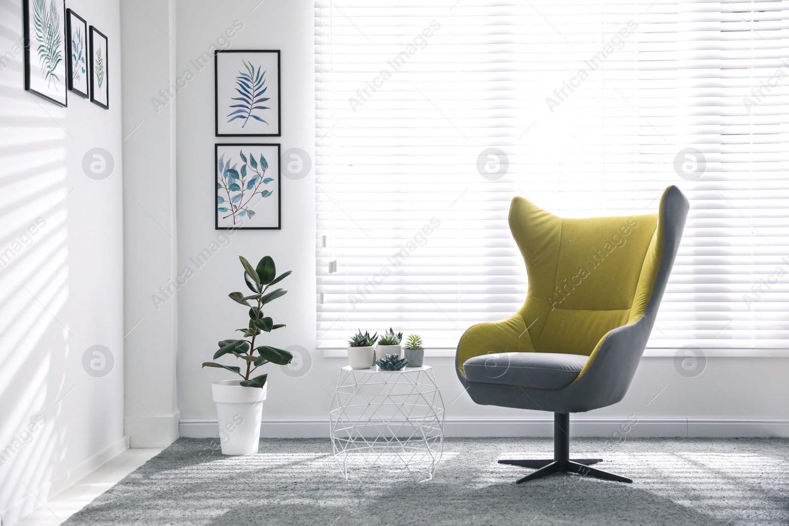 Photo of Comfortable armchair near window in light room