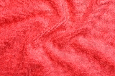 Crumpled red microfiber cloth as background, closeup