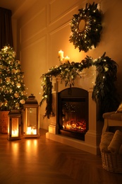 Photo of Beautiful room interior with fireplace and Christmas decor in evening