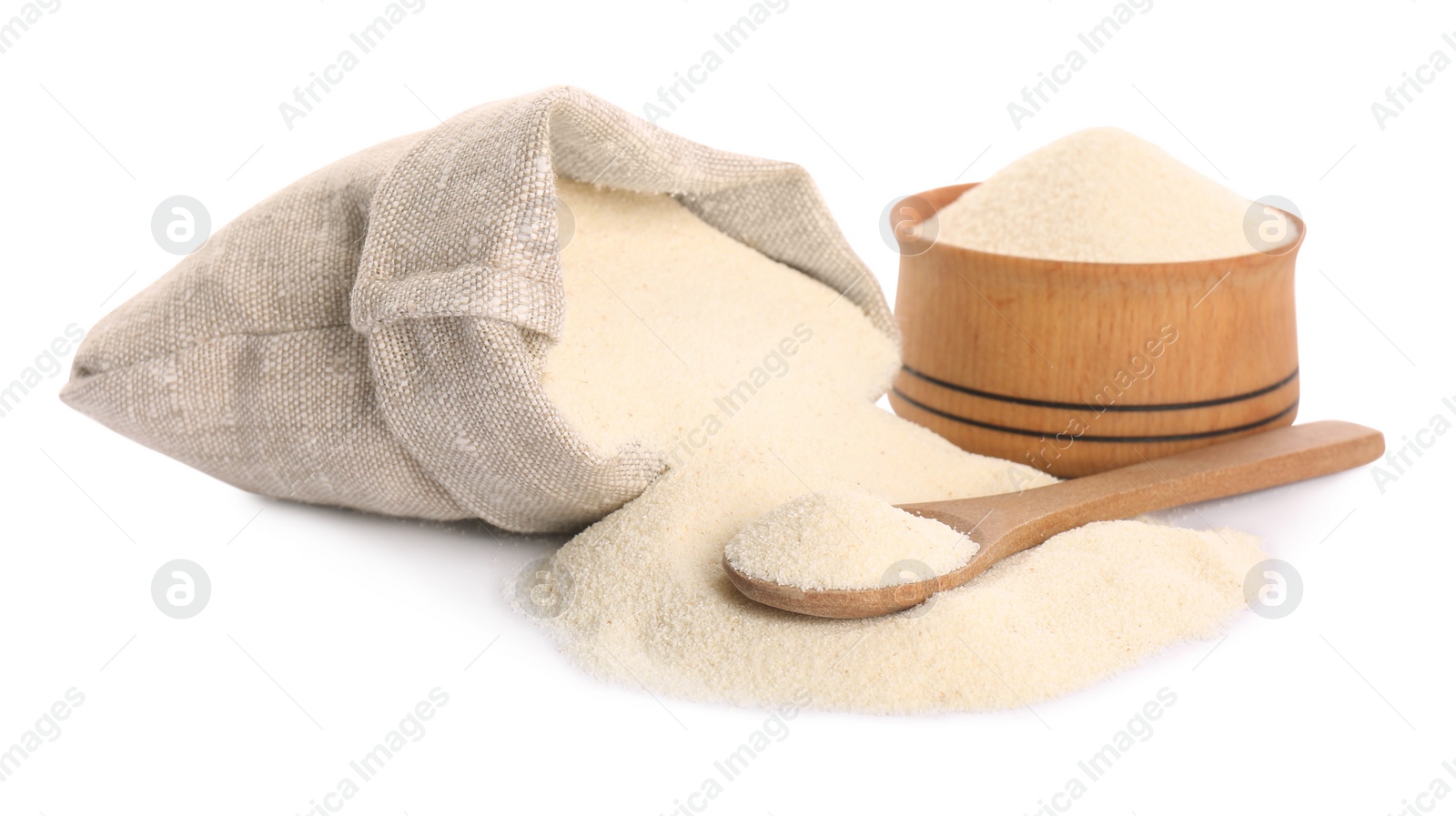 Photo of Bag, jar and spoon with semolina on white background