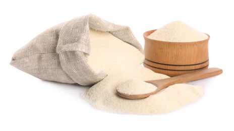 Photo of Bag, jar and spoon with semolina on white background