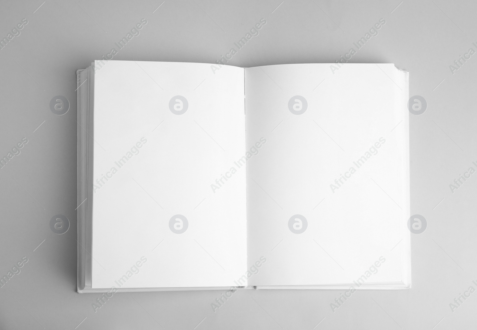 Photo of Open book with blank pages on grey background, top view