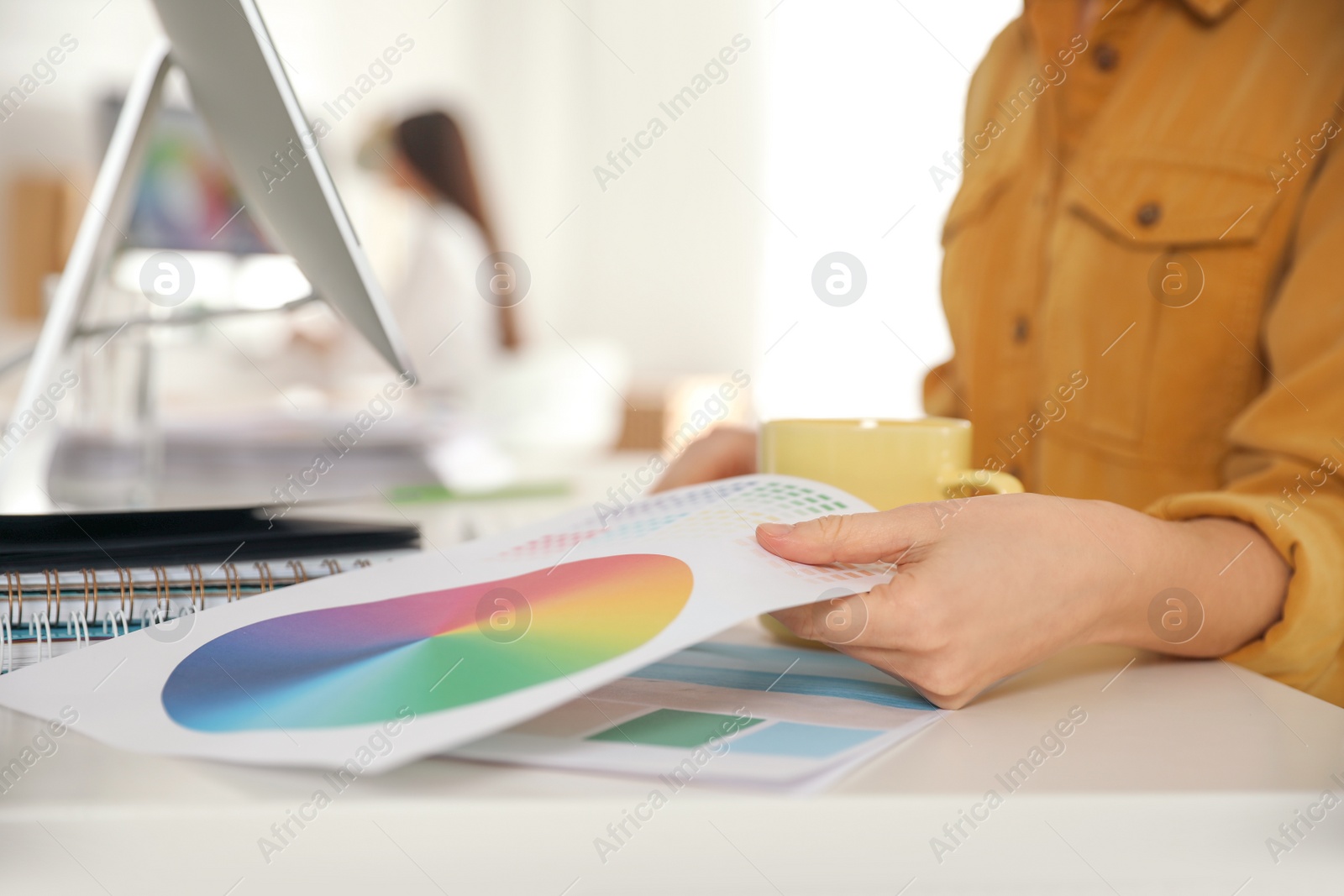 Photo of Professional designer working at table in office, closeup