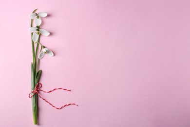 Photo of Beautiful snowdrops on pink background, top view. Space for text