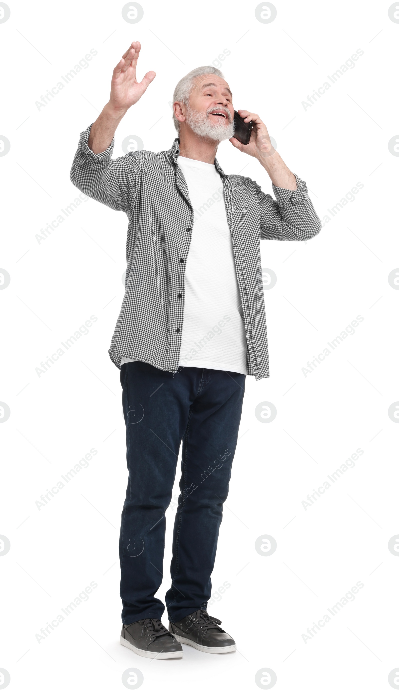 Photo of Senior man talking on smartphone against white background