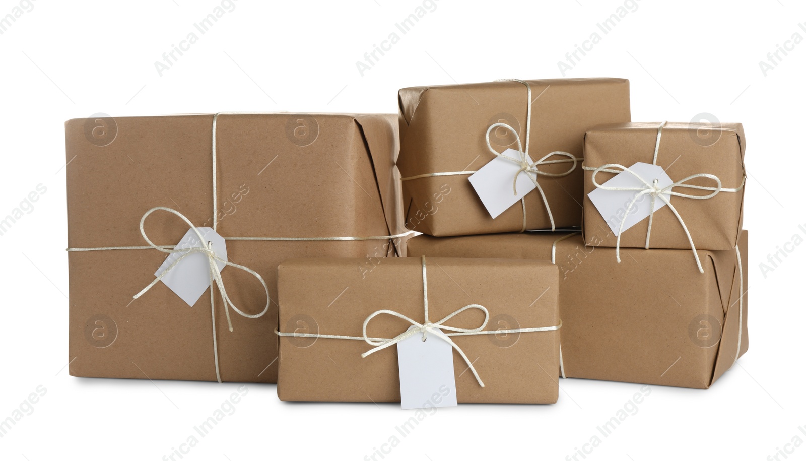 Photo of Parcels wrapped in kraft paper with tags on white background