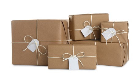 Photo of Parcels wrapped in kraft paper with tags on white background