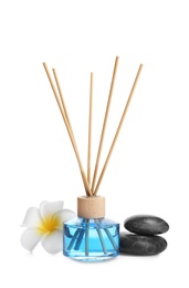 Reed air freshener, flower and spa stones on white background