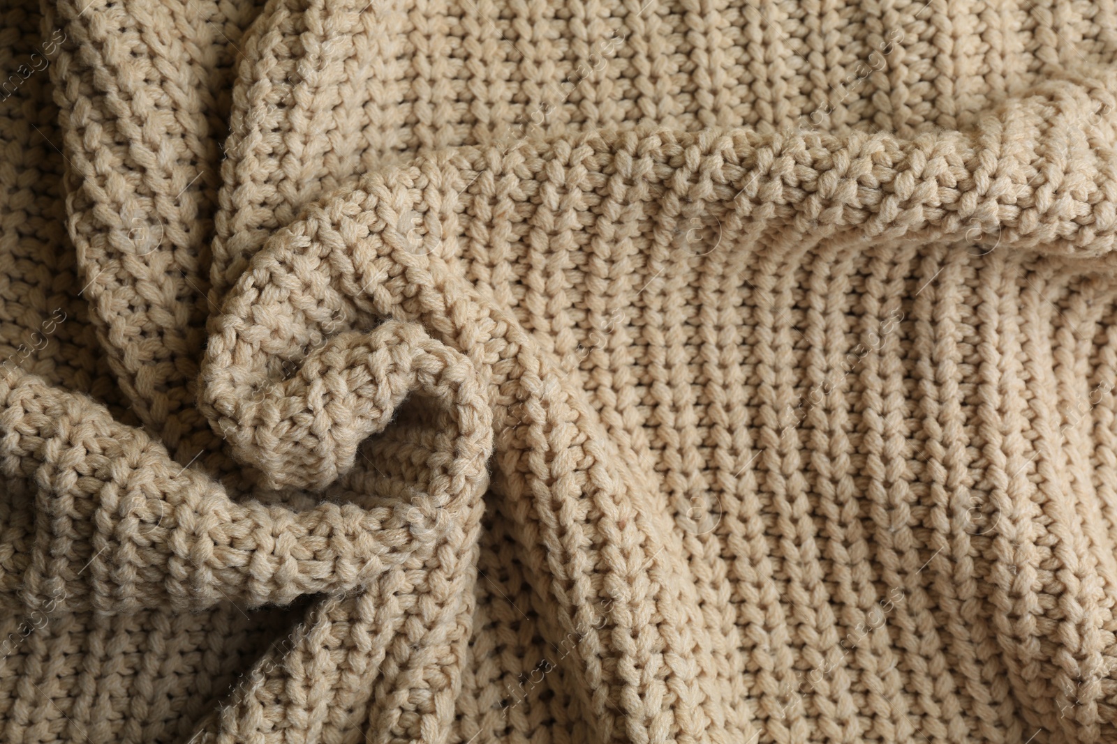 Photo of Beautiful beige knitted fabric as background, top view