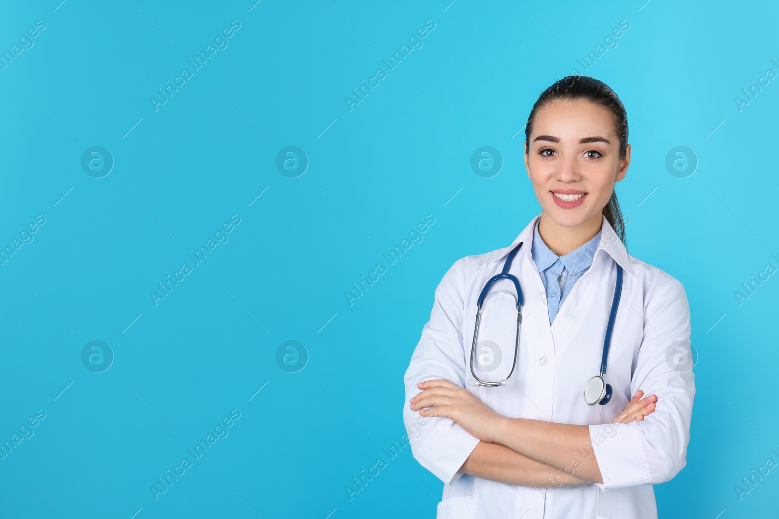 Photo of Young medical student in uniform on color background. Space for text