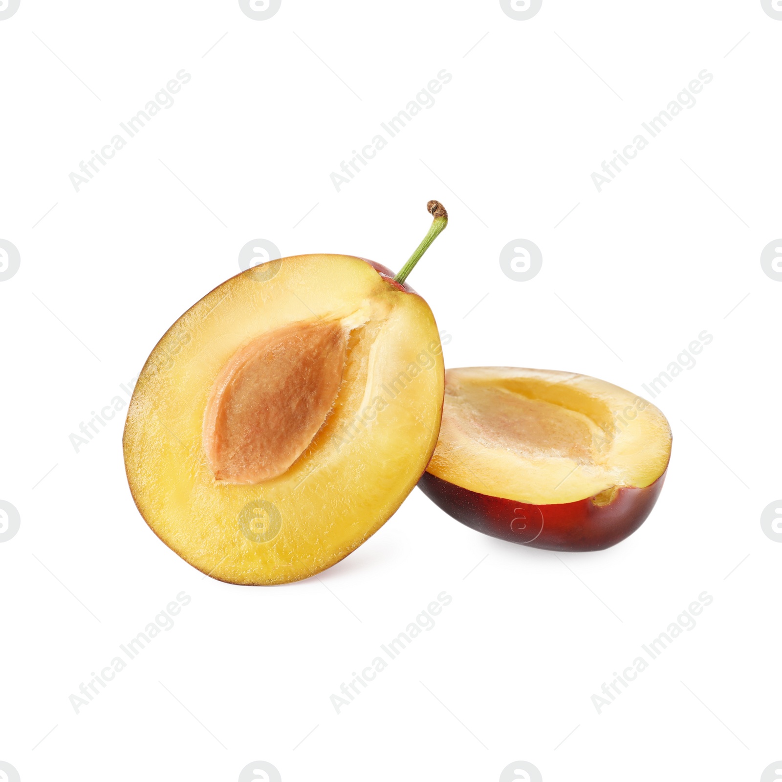 Photo of Halves of fresh ripe plum on white background