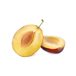 Photo of Halves of fresh ripe plum on white background