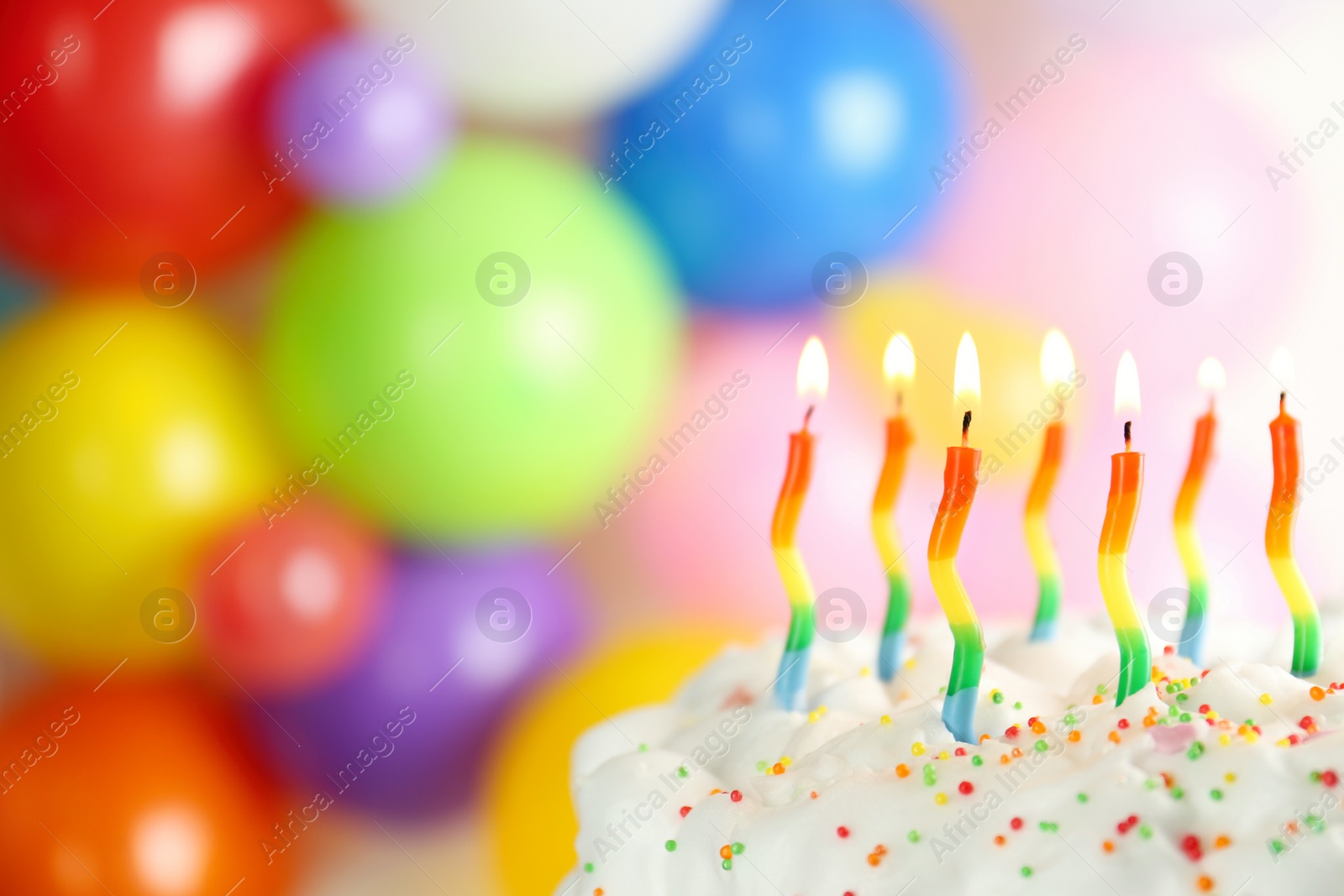 Photo of Birthday cake with burning candles on blurred background, closeup. Space for text