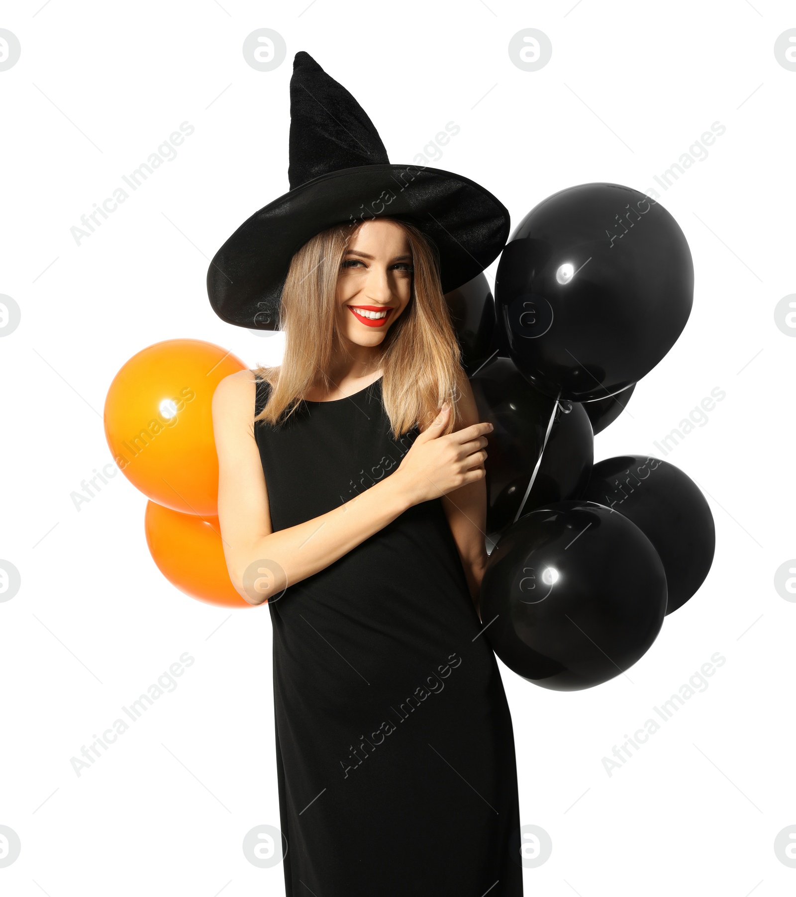 Photo of Beautiful woman wearing witch costume with balloons for Halloween party on white background