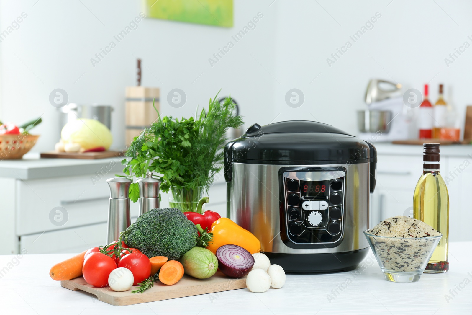 Photo of Modern multi cooker and products on kitchen table