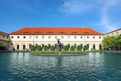 PRAGUE, CZECH REPUBLIC - APRIL 25, 2019: Pond with statues in garden of Wallenstein Palace