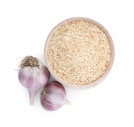 Dehydrated garlic granules in bowl and fresh bulbs isolated on white, top view