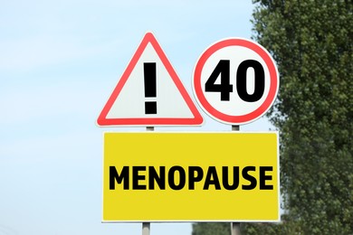 Image of Concept of impending menopause at 40 years old. Post with dIfferent signs outdoors