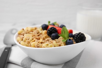 Photo of Tasty oatmeal and fresh berries in bowl on table, closeup. Healthy breakfast